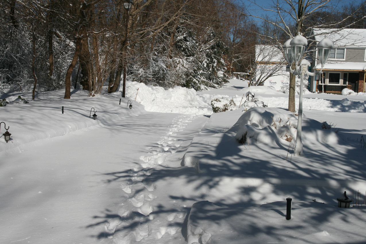 Driveway to the street  ~~  I snow blow it out, they plow me back in..........i snow it out.......they collect a few grand in taxes and plow me back in.  Its called a 