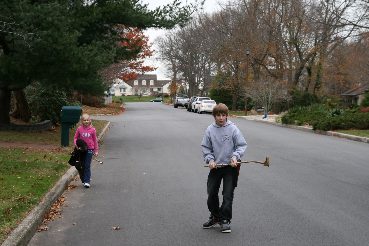 3 miles later we are beack in our neighborhood.  ~~  Mary and Quinn - draggin' it!  with their special clubs.