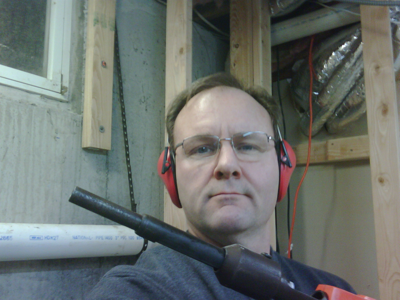 Shooting some nails in the basement  putting in studs for the room.  ~~  