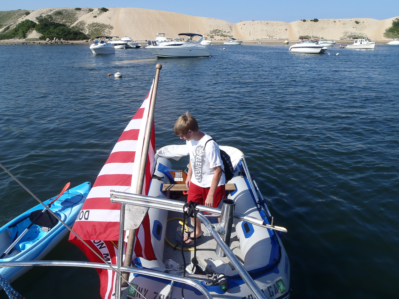 The Quinn man pumping up the dink  ~~  got a pontoon leak nagging us through the day.