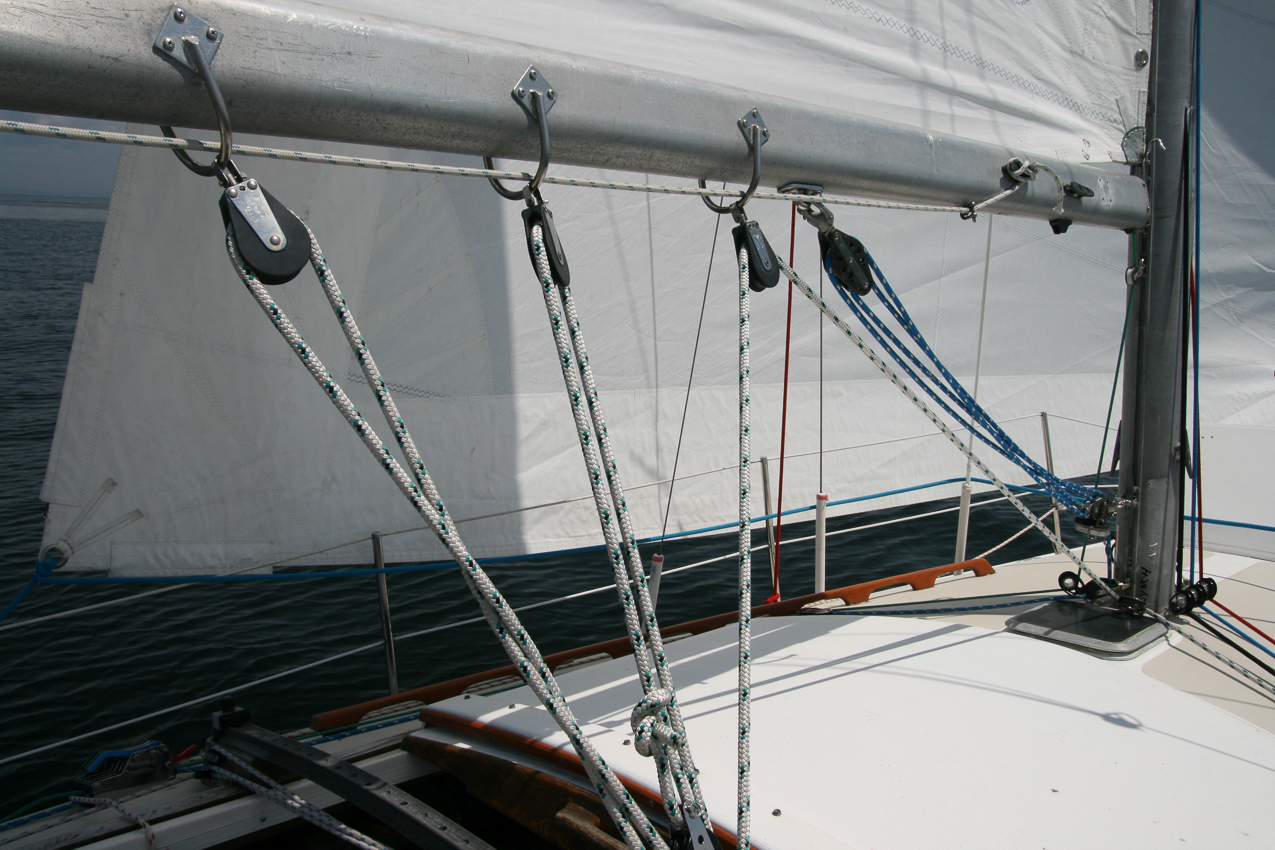 Low and mean, helps in low winds with the whisker pole!  ~~  