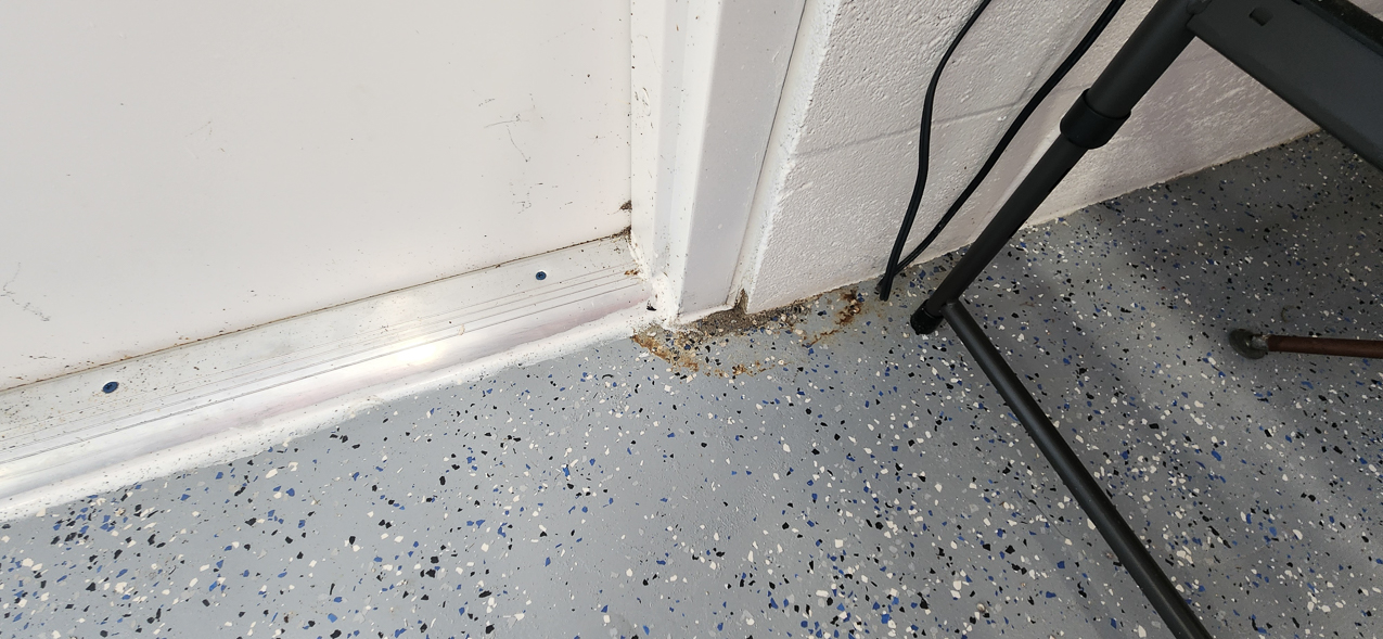 Storage East significant water aound the buidling: US Coast Guard Venice Mission Support & Training Center September 2025  ~~  Storage Building Roof and Door leaks