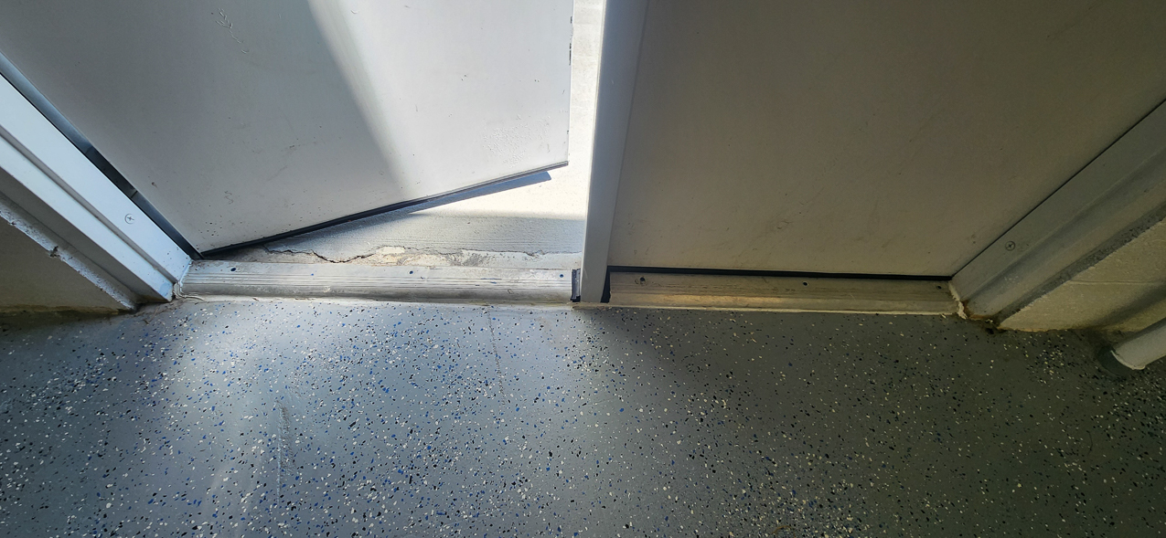 Storage East significant water aound the buidling: US Coast Guard Venice Mission Support & Training Center September 2025  ~~  Storage Building Roof and Door leaks