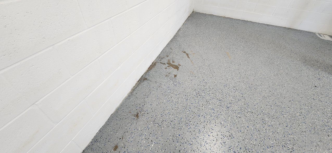 Storage East significant water aound the buidling: US Coast Guard Venice Mission Support & Training Center September 2025  ~~  Storage Building Roof and Door leaks