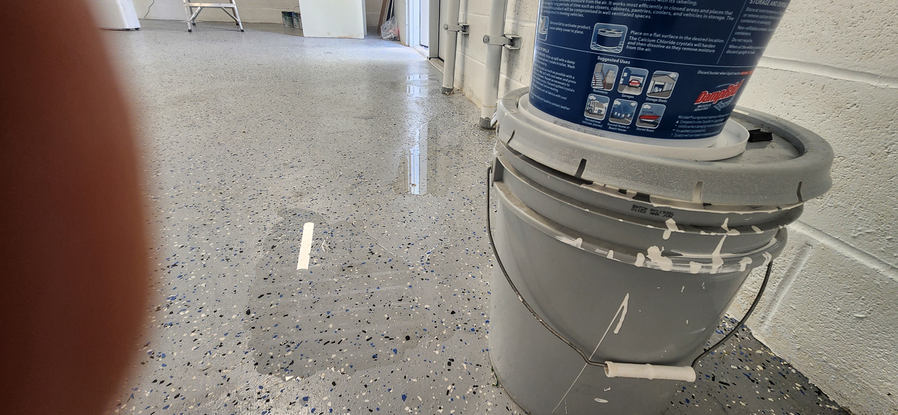 Storage East significant water aound the buidling: US Coast Guard Venice Mission Support & Training Center September 2025  ~~  Storage Building Roof and Door leaks