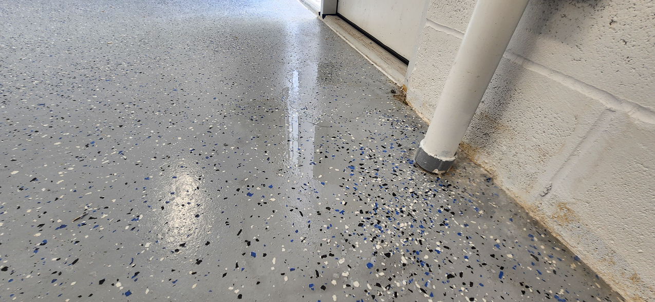 Storage East significant water aound the buidling: US Coast Guard Venice Mission Support & Training Center September 2025  ~~  Storage Building Roof and Door leaks